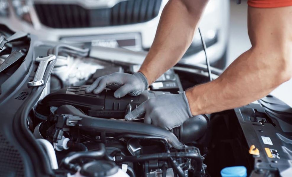 Mechanic working on car engine